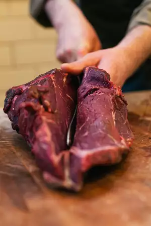 One of Ginger Pig's butchers at work
