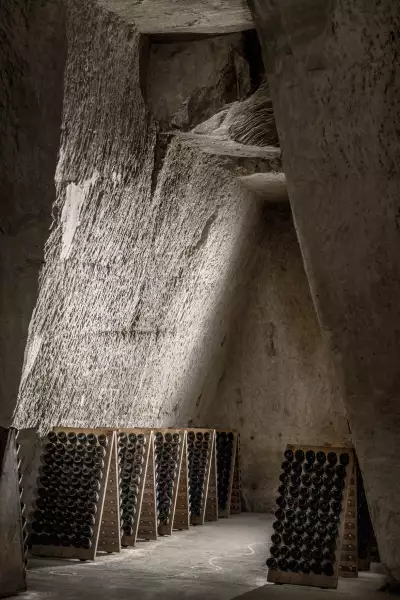 Bottles waiting to be riddled in the historical chalk quarry cellars at Maison Ruinart