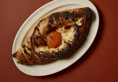 Khachapuri at Holy Carrot, which has introduced dairy to its new Spitalfields opening Khachapuri at Holy Carrot, which has introduced dairy to its new Spitalfields opening