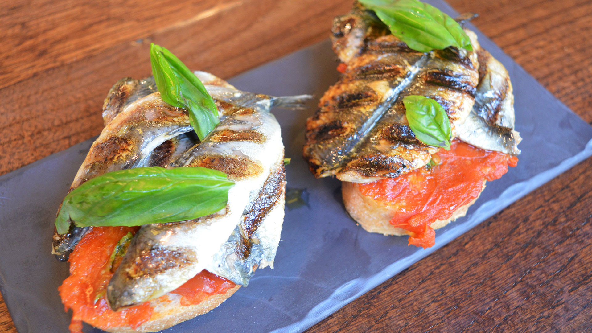 Ember Yard's grilled sardines on toast with tomato and fresh basil Ember Yard's grilled sardines on toast with tomato and fresh basil