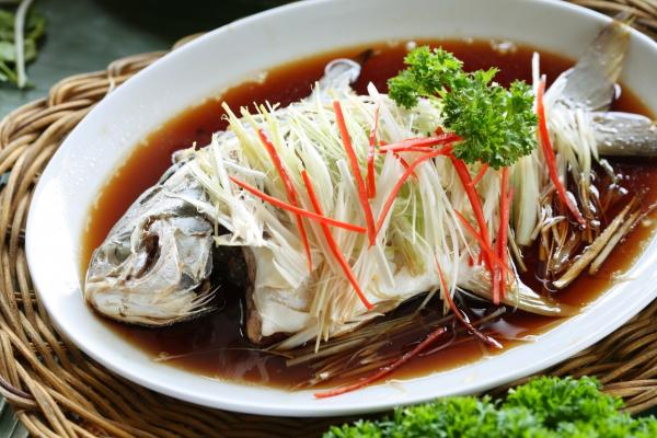 Chinese-style marinated steamed fish with spring onion