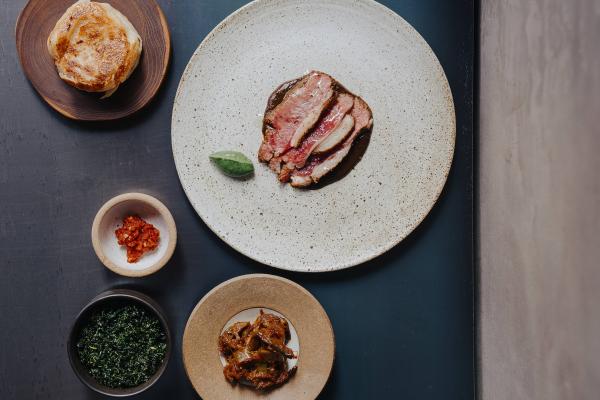 Lamb saddle, black garlic curry, nettle and coconut with fried long aubergine and jaggery moju and a hand-stretched buttermilk roti