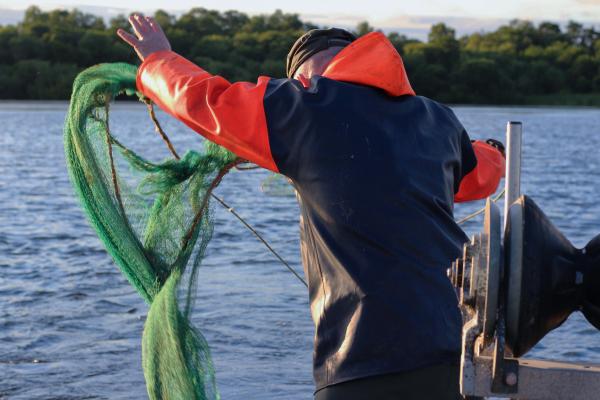 Gary McErlain casting out an eel fishing net on Lough Neagh