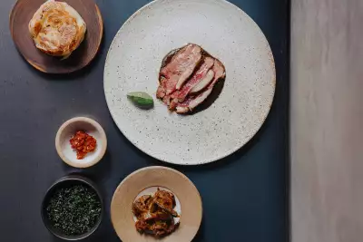 Lamb saddle, black garlic curry, nettle and coconut with fried long aubergine and jaggery moju and a hand-stretched buttermilk roti
