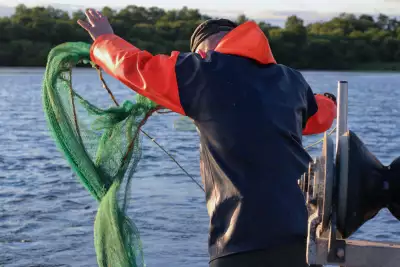 Gary McErlain casting out an eel fishing net on Lough Neagh