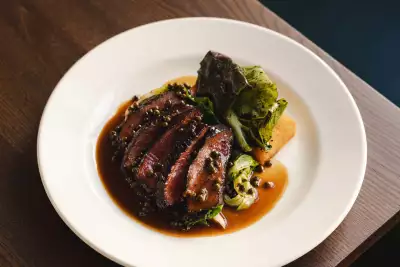 Highland flat iron, mustard greens, Pommes Anna and peppercorn sauce