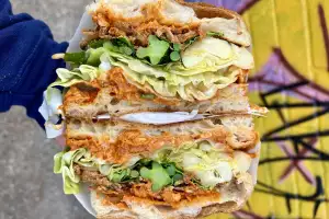 Purple sprouting broccoli, charred hispi, hazelnut and almond romesco and crispy shallot sandwich
