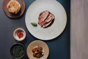 Lamb saddle, black garlic curry, nettle and coconut with fried long aubergine and jaggery moju and a hand-stretched buttermilk roti