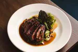 Highland flat iron, mustard greens, Pommes Anna and peppercorn sauce