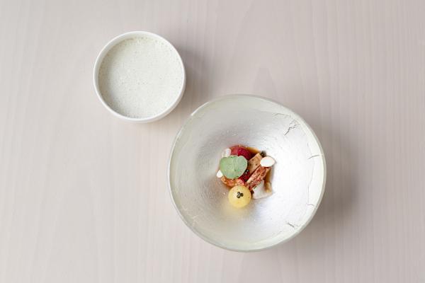 Scottish lobster with garlic caper jangajji, dongchimi, and strawberry, served with a lobster shell reduction and finished with baby artichoke foam Scottish lobster with garlic caper jangajji, dongchimi, and strawberry, served with a lobster shell reduction and finished with baby artichoke foam