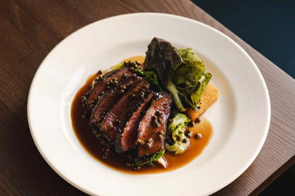 Highland flat iron, mustard greens, Pommes Anna and peppercorn sauce Highland flat iron, mustard greens, Pommes Anna and peppercorn sauce