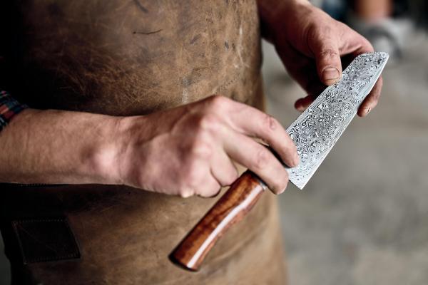Ben Bodman admires the pattern welding on a Damascus steel blade at Bodman Knives Ben Bodman admires the pattern welding on a Damascus steel blade at Bodman Knives