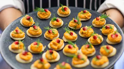 Saima Khan holding a plate of canap&eacute;s