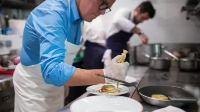 Alain Passard prepares a dish at L'Arp&egrave;ge