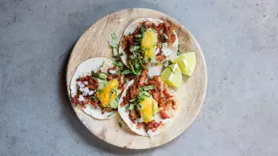 Pork tacos at El Pastor, with pineapple, guacamole, white onion and coriander