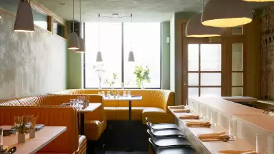 The interior design of Cub combines a vibrant colour scheme with a pared-down aesthetic and classic marble bar
