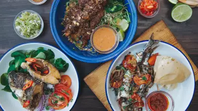 Clockwise from top: chichinga beef kebabs, sardine with kenkey and fried tilapia