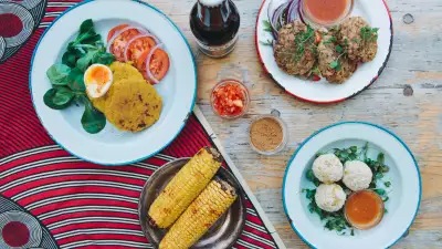 Clockwise from top left: oto cakes, koose fritters, yam balls, roasted corn
