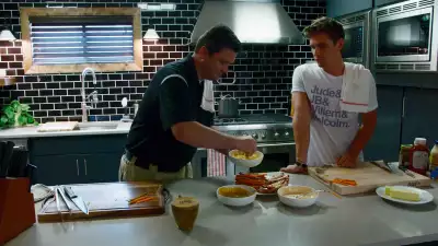 Antoni showing Jeremy how to grill hot dogs in season one episode eight