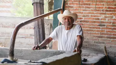 A mezcalero in the a mezcal palenque in Oaxaca