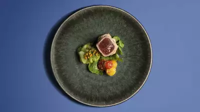 Seared tuna with tamarind roast potatoes, cucumber and pistachios