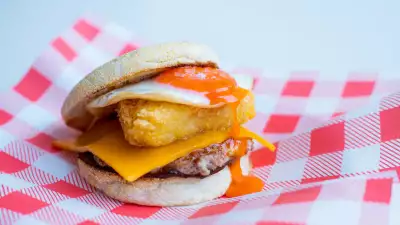 The sausage, egg, red Leicester and brown sauce muffin