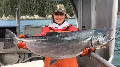 Carley Moller holding up an Alaskan salmon