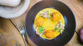 Spiced sweet potato fritters with grilled pineapple, cured red onions and saffron coconut curry
