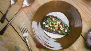 Aubergine with pomegranate, dates, chilli lime yoghurt, puffed quinoa and feta