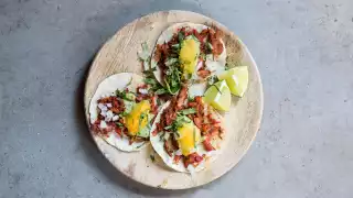 Pork tacos at El Pastor, with pineapple, guacamole, white onion and coriander