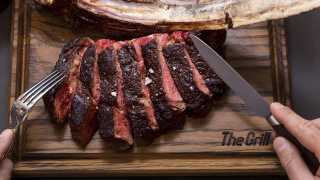 The Grill at McQueen medium rare tomahawk steak off the bone to share between two