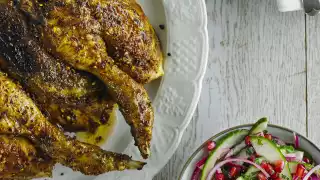 Alexandra Dudley's spatchcocked Persian peanut chicken with crunchy cabbage slaw; Photograph by Andrew Burton