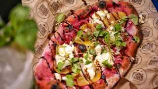 Born & Raised's pizza with Somerset goats' cheese with caramelised red onion on beetroot-infused dough
