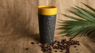 rCUP's reusable coffee cup in mustard and black