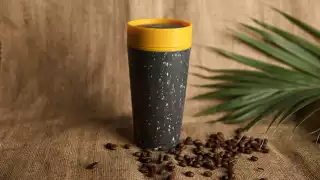 rCUP's reusable coffee cup in mustard and black