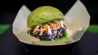 A burger with a green bun