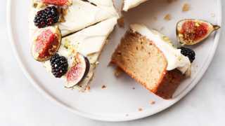 A beautiful bake covered in vanilla frosting, blackberries and fresh figs