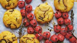 Make Eleanor Maidment's courgette and pecorino polenta cakes with vine-roasted tomatoes and dry-cured ham