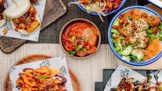 best places to eat vegan food in london, noodle salad, kimchi, bibimbap, pickled daikon, cucumber and Korean fried tofu at Eat Chay