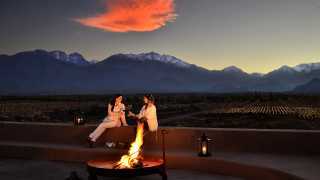 Sharing a glass of wine at the rooftop of Alpasion Lodge in the foreground of the Andes
