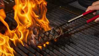 Flaming steak on the grill