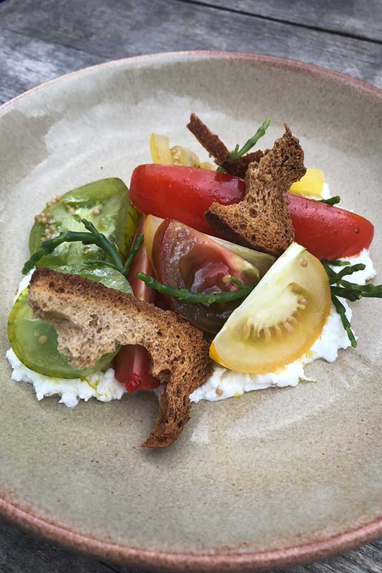 Tomatoes, goats curd, pickled mustard seed, samphire, crouton, elderflower and tarragon vinaigrette from Oxalis