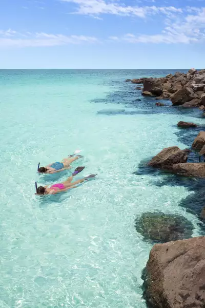 Two children snorkel in the gin-clear waters by Panama City beach in the Florida Panhandle