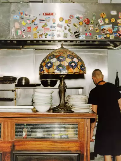 Two chefs cooking dinner in the open kitchen of The Plimsoll pub in Finsbury Park