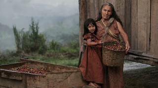 A farmer holds her daughter in Peru