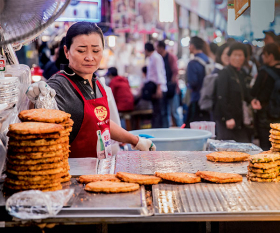 Things to do in Seoul, South Korea: A street-food trader cooks pajeon, spring onion pancakes