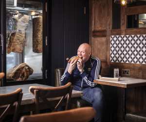 Tom Kerridge enjoying a hotdog at The Butcher's Tap & Grill