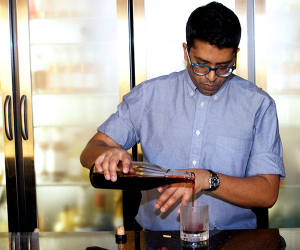 White Lyan's Chetiyawardana pouring a cocktail in his bar