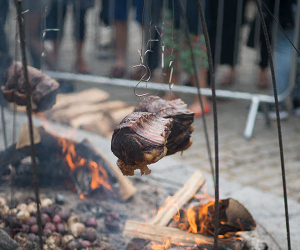 Meat cooking over a fire at Meatopia 2016