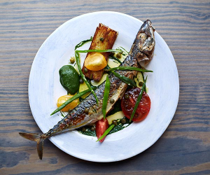 This one's for sharing, whole mackerel with potato cake and confit tomatoes